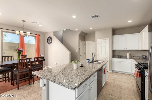 3914 S 58th Ln, Phoenix, AZ 85043 - kitchen with black gas range, a sink, white cabinets, light tile patterned flooring, and recessed lighting