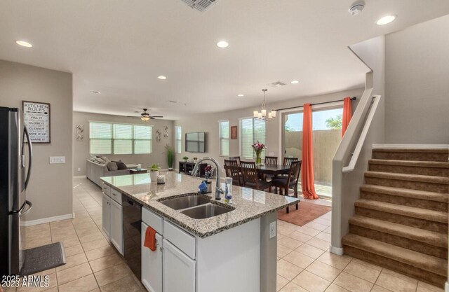 3914 S 58th Ln, Phoenix, AZ 85043 - kitchen with a sink, freestanding refrigerator, open floor plan, light tile patterned flooring, and a center island with sink