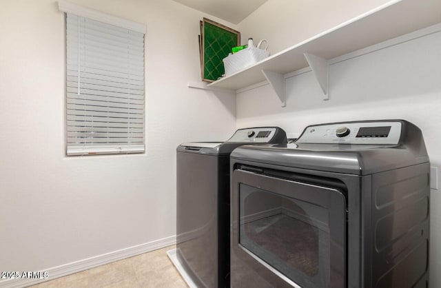 3914 S 58th Ln, Phoenix, AZ 85043 - laundry area with washer and clothes dryer, baseboards, and light tile patterned floors