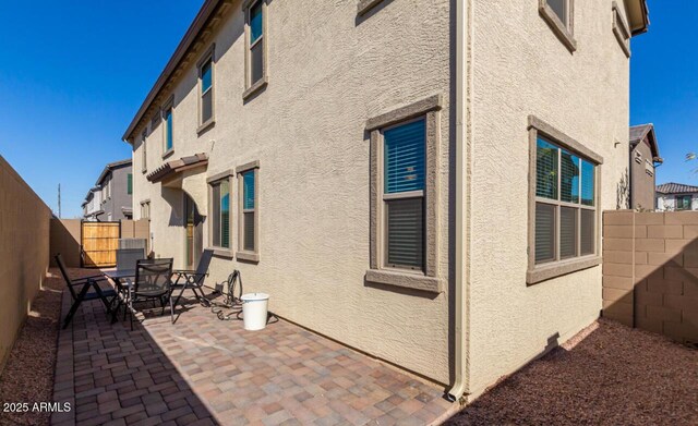 3914 S 58th Ln, Phoenix, AZ 85043 - view of side of property featuring a patio area, stucco siding, and a fenced backyard