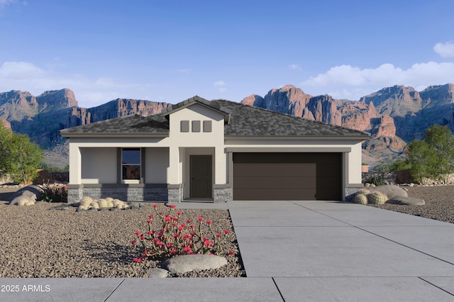 view of front facade with a mountain view and a garage