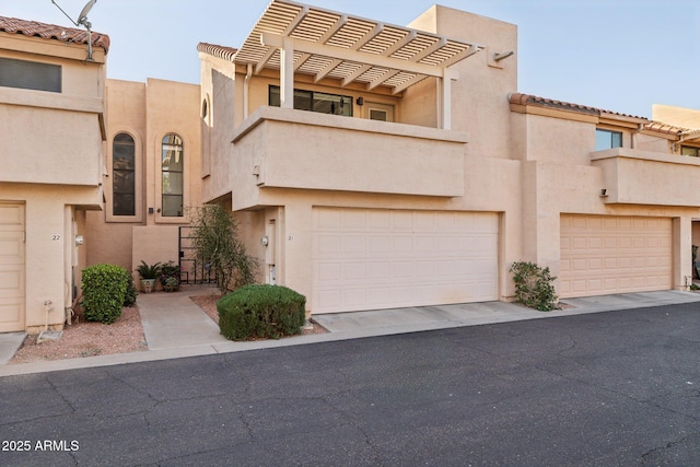 multi unit property with a garage and a pergola