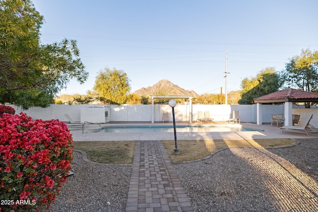 view of yard with a mountain view, a gazebo, a fenced in pool, and a patio