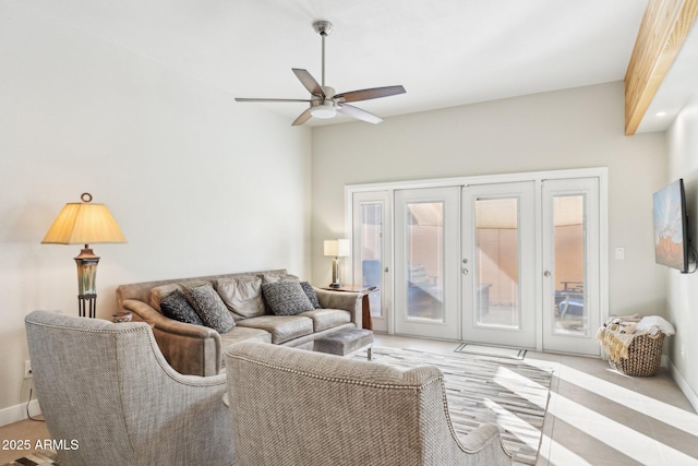 living room featuring ceiling fan and french doors