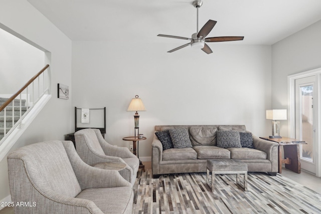 living room with ceiling fan, plenty of natural light, and light hardwood / wood-style floors