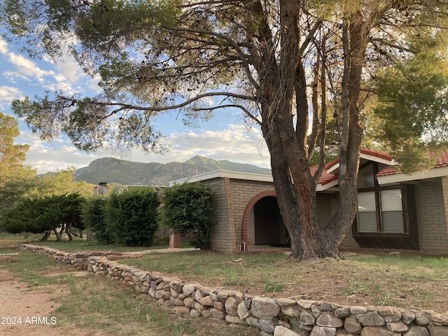 view of side of home with a mountain view