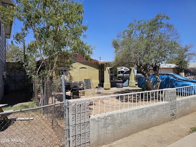6706 N 54th Dr, Glendale, AZ 85301 - obstructed view of property with a fenced front yard, stucco siding, and a gate