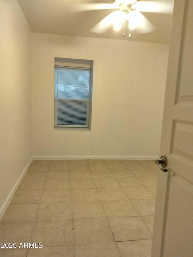 6706 N 54th Dr, Glendale, AZ 85301 - empty room with light tile patterned floors, a ceiling fan, and baseboards