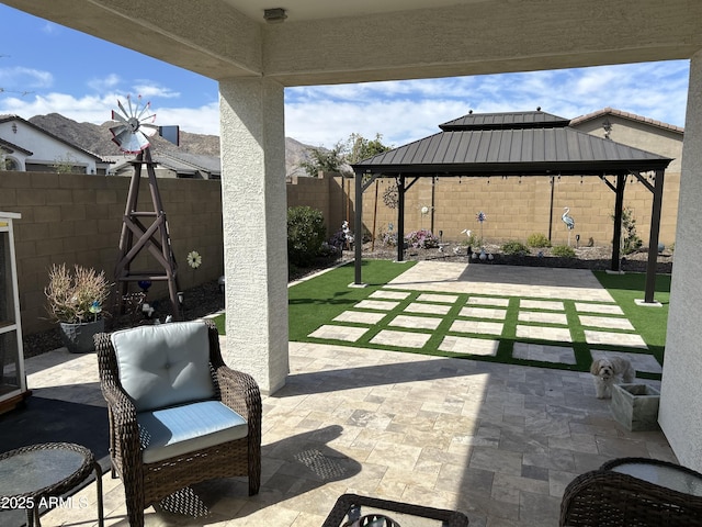 view of patio / terrace featuring a gazebo and a fenced backyard