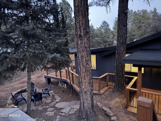 view of property exterior with a patio and a wooden deck