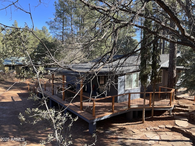 rear view of property featuring a deck