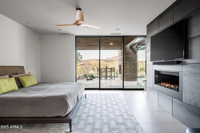 tiled bedroom with expansive windows and access to outside