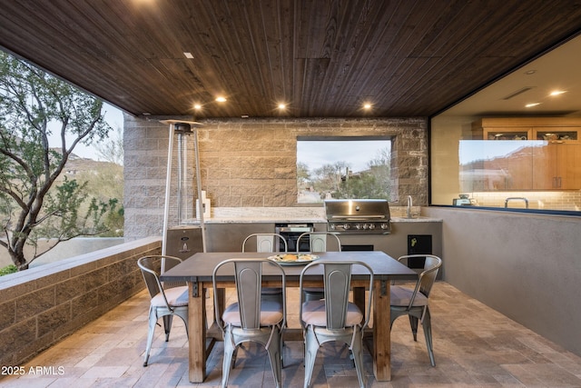 patio terrace at dusk with area for grilling and a mountain view