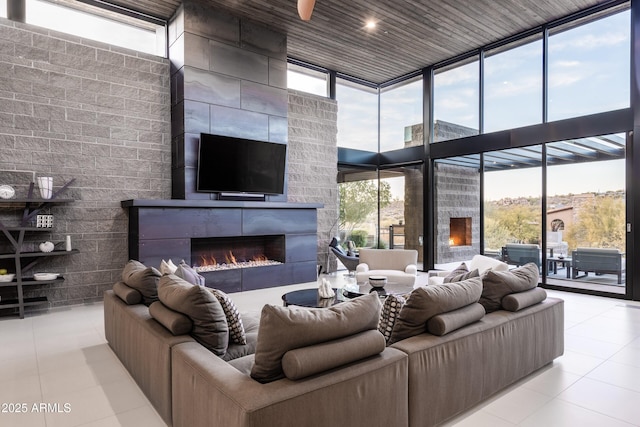 tiled living room featuring a wall of windows and wooden ceiling