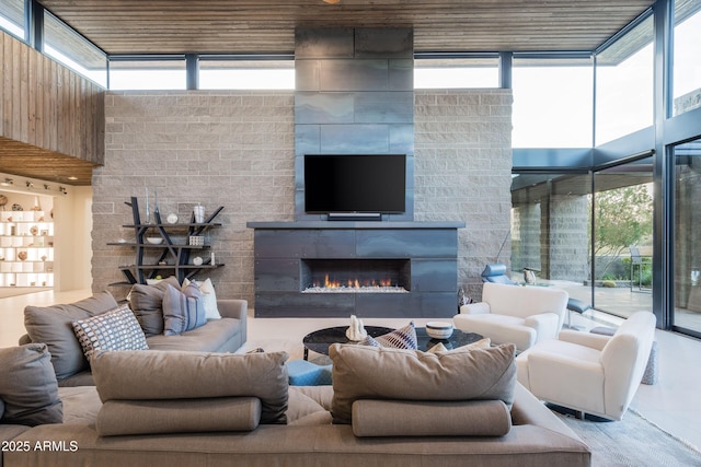 living room with a fireplace and floor to ceiling windows