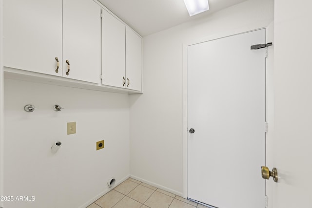 clothes washing area with light tile patterned floors, baseboards, cabinet space, and hookup for an electric dryer