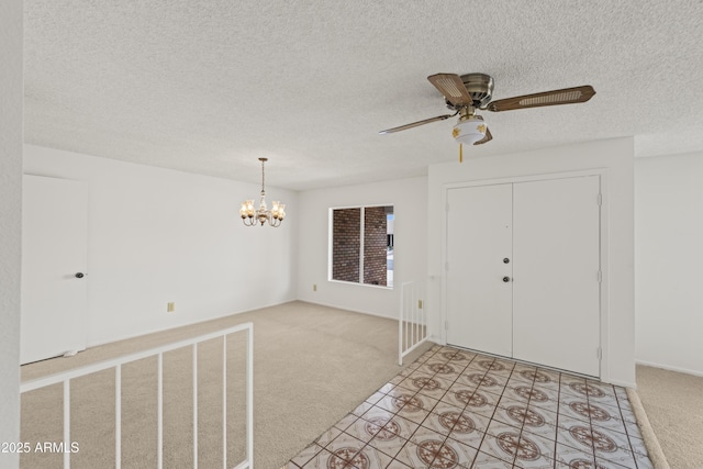 foyer entrance with light carpet, a textured ceiling, and ceiling fan with notable chandelier