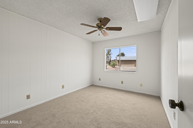 unfurnished room featuring ceiling fan, a textured ceiling, and carpet