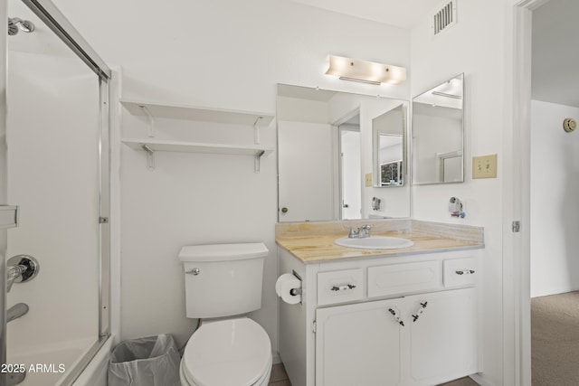 bathroom with combined bath / shower with glass door, visible vents, toilet, and vanity