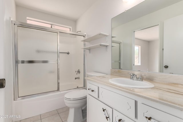 full bath featuring enclosed tub / shower combo, toilet, vanity, and tile patterned flooring