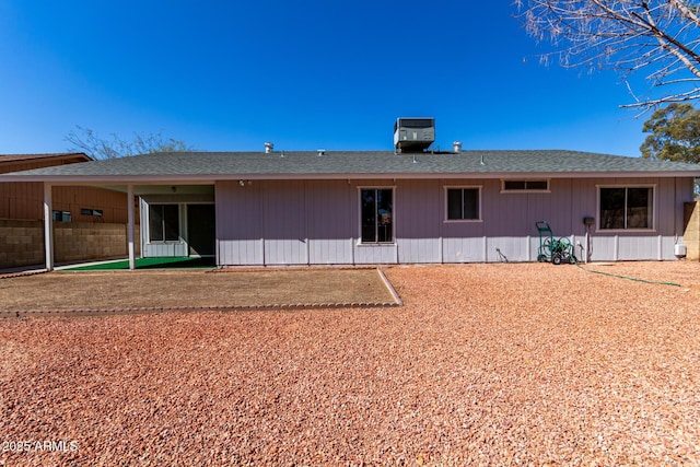 back of property featuring central AC