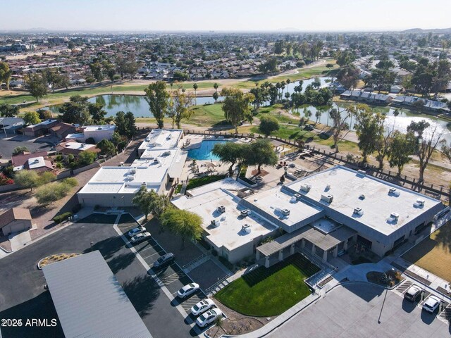 aerial view featuring golf course view, a water view, and a residential view