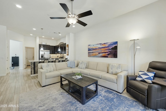 living area with recessed lighting and a ceiling fan