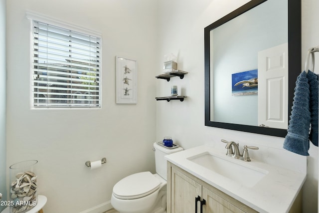 half bath featuring toilet and vanity