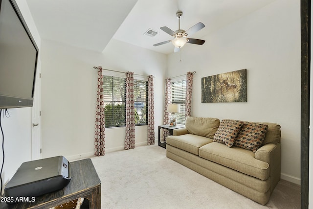 carpeted living room featuring baseboards, visible vents, and ceiling fan