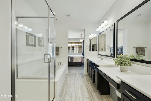 bathroom featuring visible vents, a shower stall, ensuite bath, and vanity