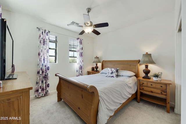 bedroom featuring visible vents, light colored carpet, baseboards, and ceiling fan