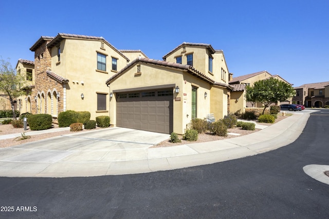 view of front of home featuring stucco siding, a garage, driveway, and a tiled roof