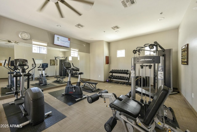 gym featuring a ceiling fan, visible vents, and baseboards