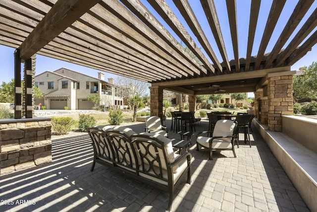 view of patio featuring outdoor dining space, a ceiling fan, and a pergola