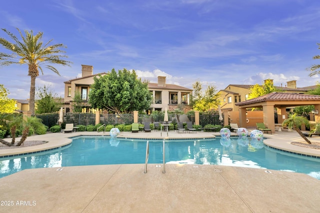 pool featuring a patio and fence