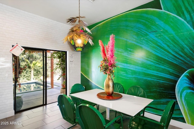 dining space with brick wall