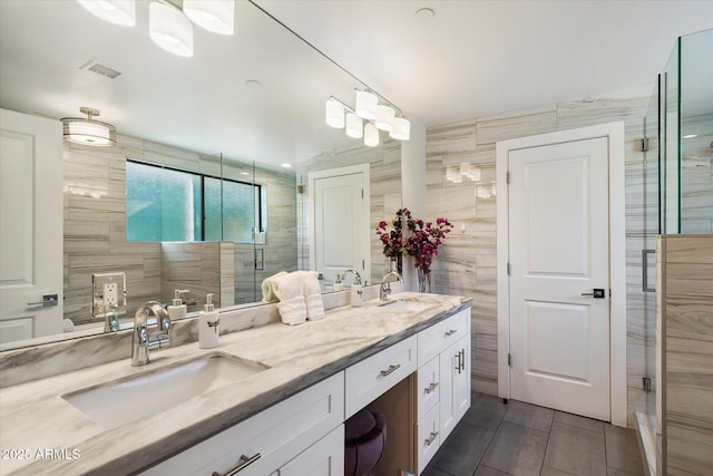 bathroom featuring vanity, tile walls, tile patterned floors, and walk in shower