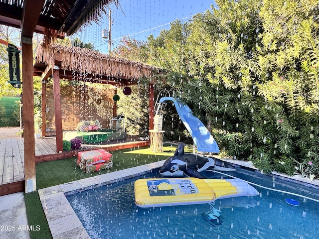 view of swimming pool featuring a water slide