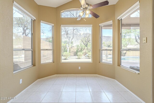sunroom featuring ceiling fan