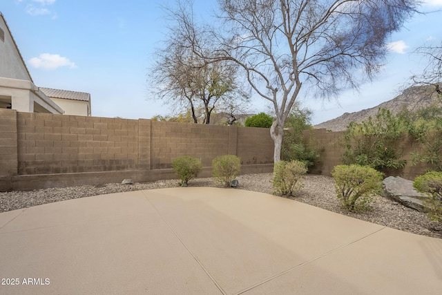 view of patio with a fenced backyard and a mountain view