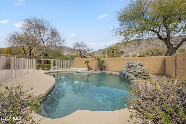 view of pool with a fenced in pool, a fenced backyard, and a mountain view