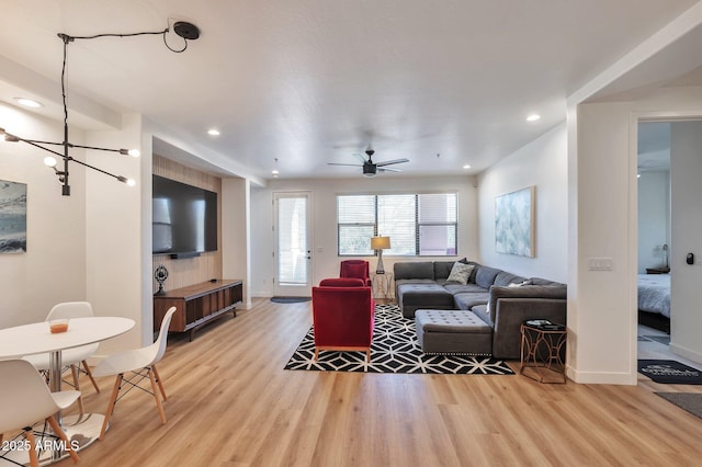 living room featuring ceiling fan and light wood-type flooring