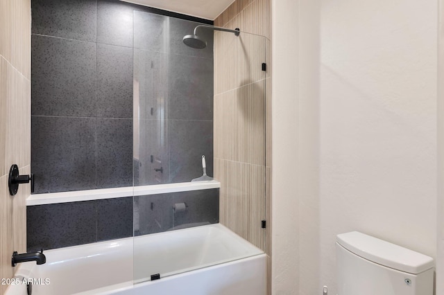 bathroom with toilet and tiled shower / bath combo