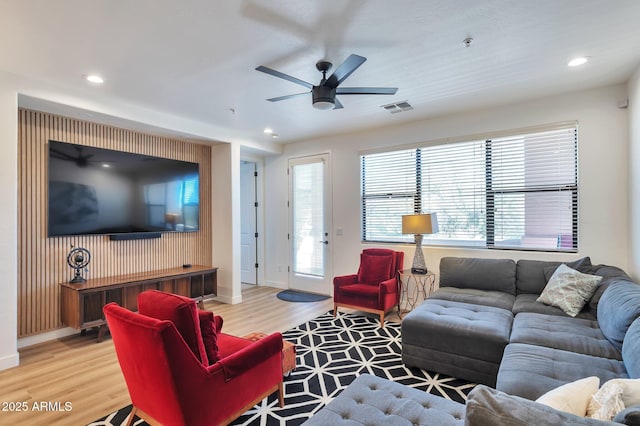 living room with wood-type flooring and ceiling fan