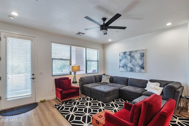 living room featuring hardwood / wood-style flooring and ceiling fan