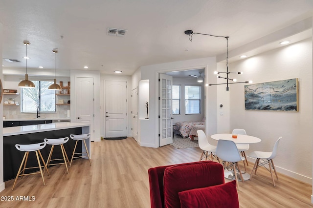 dining area featuring sink and light hardwood / wood-style flooring