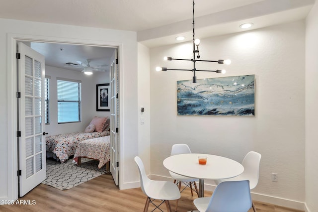 dining room with wood-type flooring and a chandelier