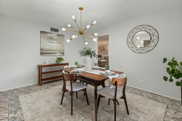 dining room with baseboards, visible vents, a chandelier, and a textured ceiling