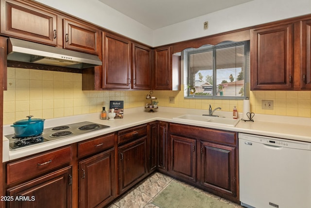 kitchen with light countertops, stainless steel electric cooktop, a sink, dishwasher, and under cabinet range hood