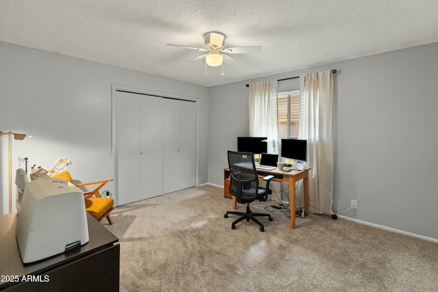 office area with baseboards, carpet, a ceiling fan, and a textured ceiling